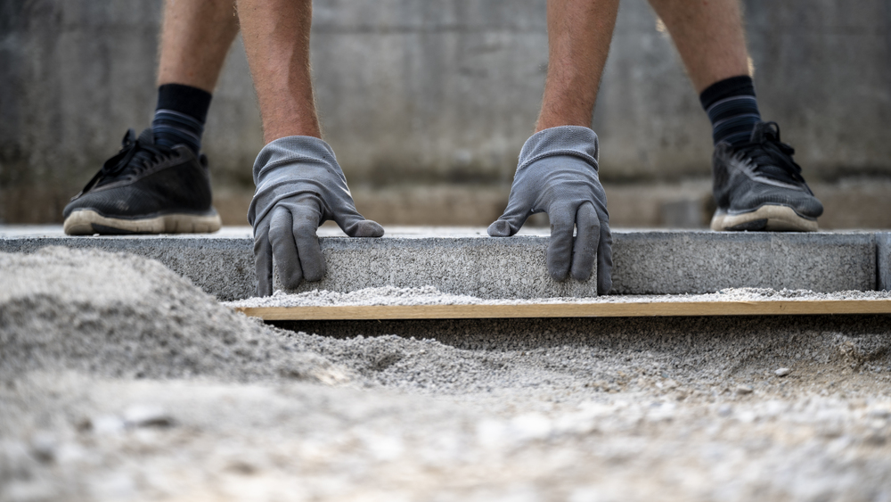 construction-worker-laying-pavers-for-a-new-path-2026-09-21-19-35-56-utc-1