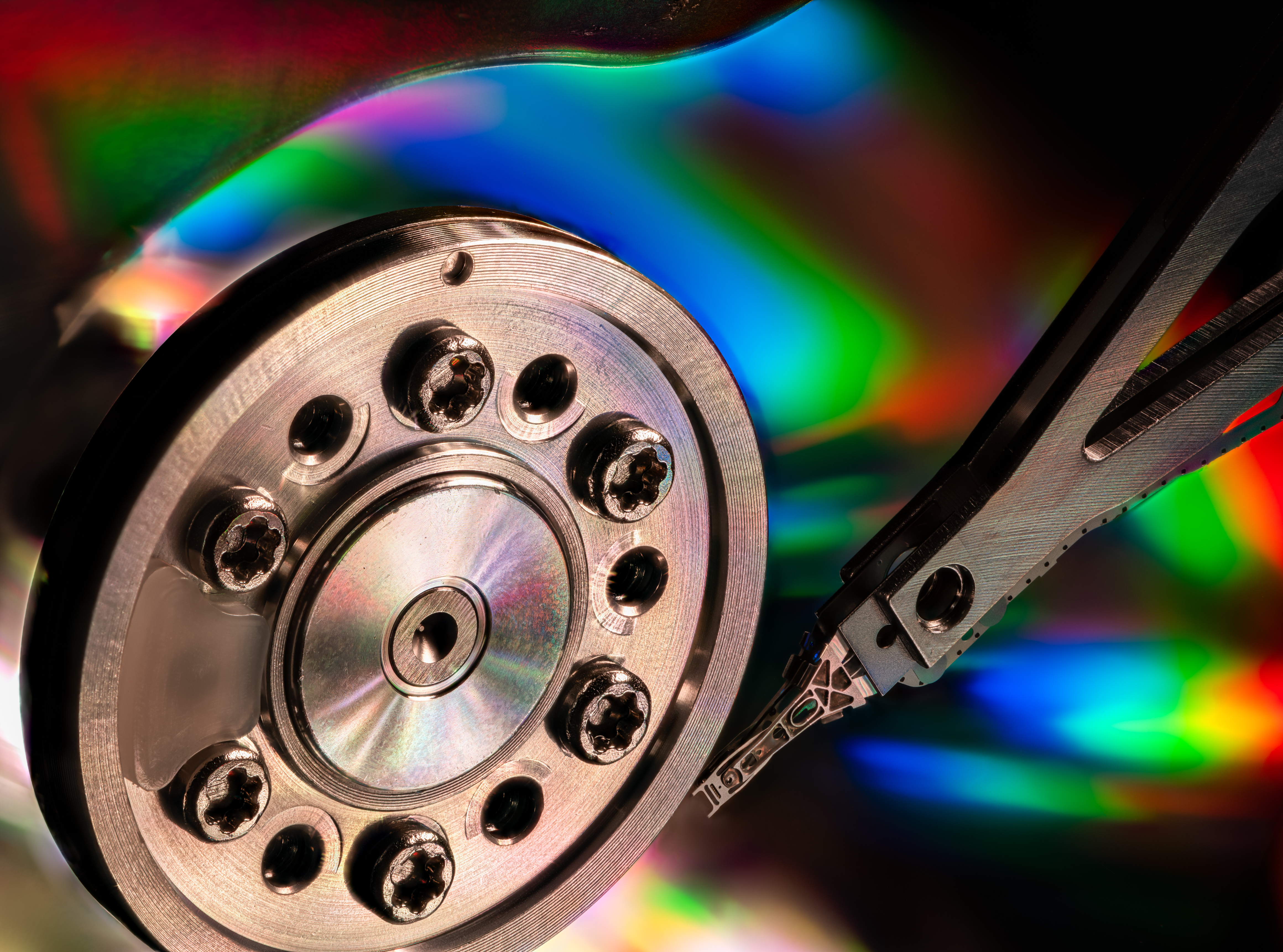 Close-up of an open hard disk drive with rainbow reflections, illustrating that “having backups” is only one part of a wider resilience and recovery strategy.